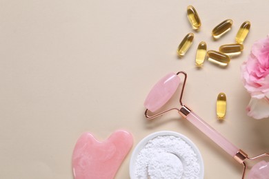 Photo of Flat lay composition with collagen capsules and flower on beige background. Space for text