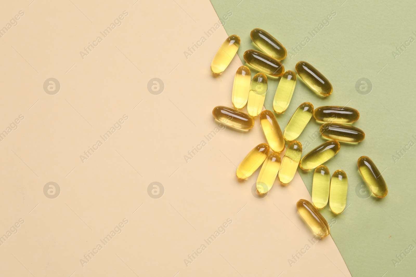 Collagen capsules on color background, top view. Space for text Photo of Collagen capsules on color background, top view. Space for text