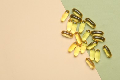 Photo of Collagen capsules on color background, top view. Space for text