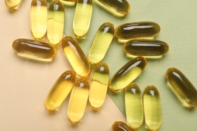 Photo of Collagen capsules on color background, top view