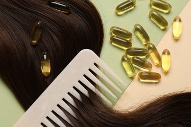 Photo of Collagen capsules, hair lock and comb on color background, flat lay