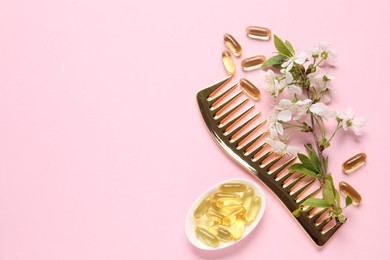 Photo of Collagen capsules, blossoms and comb on pink background, flat lay. Space for text