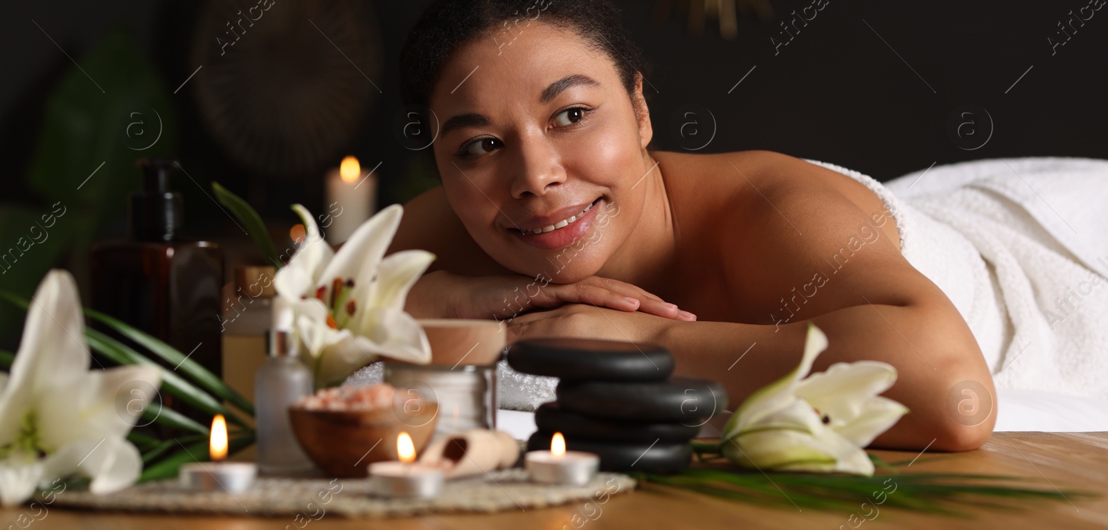 Beautiful woman relaxing on massage couch in spa salon Photo of Beautiful woman relaxing on massage couch in spa salon