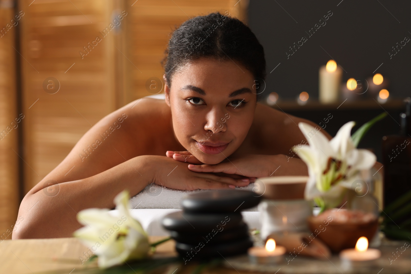 Beautiful woman relaxing on massage couch in spa salon Photo of Beautiful woman relaxing on massage couch in spa salon