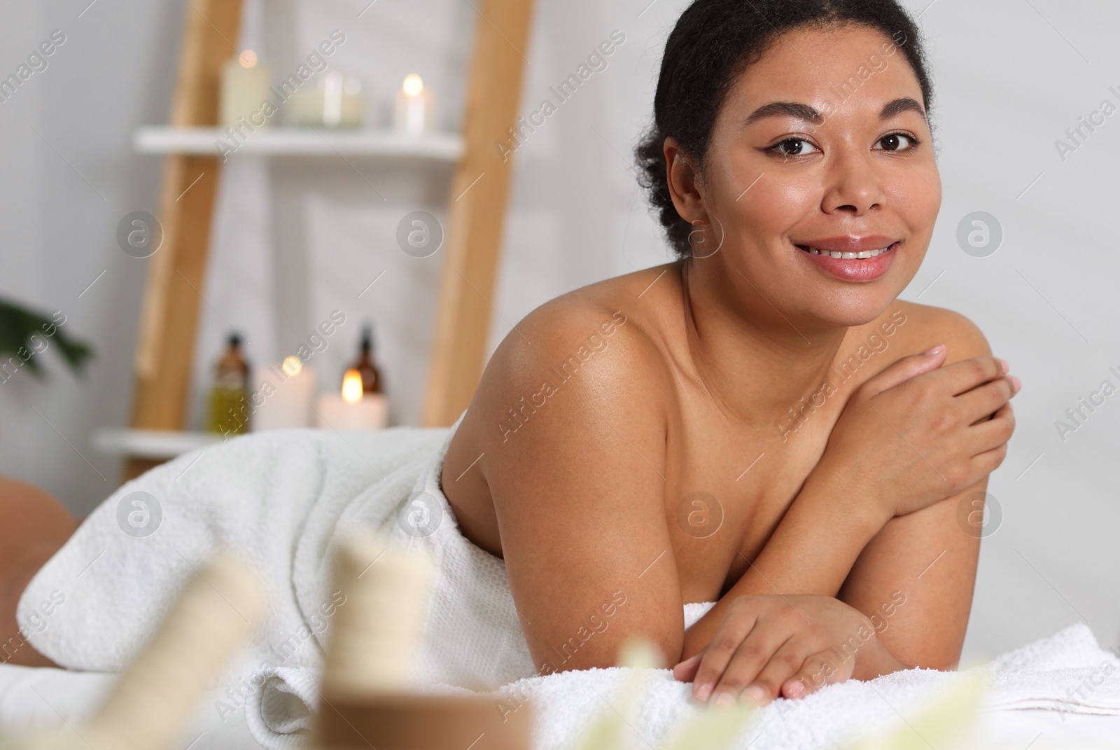 Beautiful woman relaxing on massage couch in spa salon Photo of Beautiful woman relaxing on massage couch in spa salon
