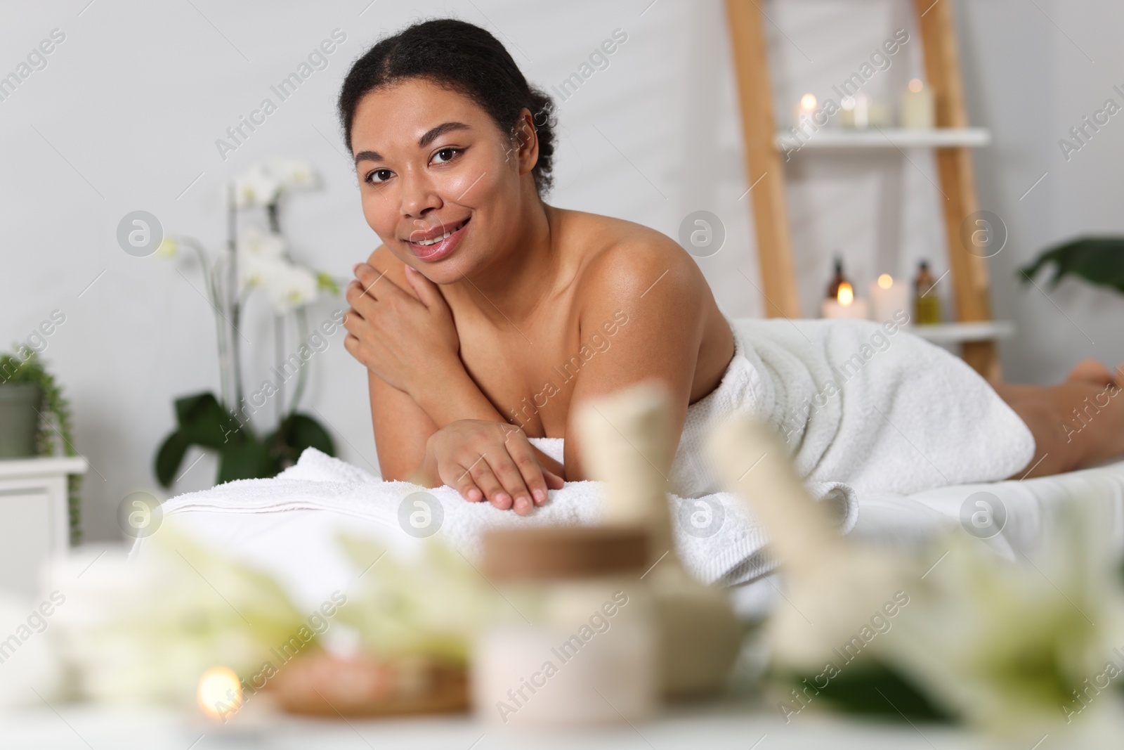 Beautiful woman relaxing on massage couch in spa salon Photo of Beautiful woman relaxing on massage couch in spa salon