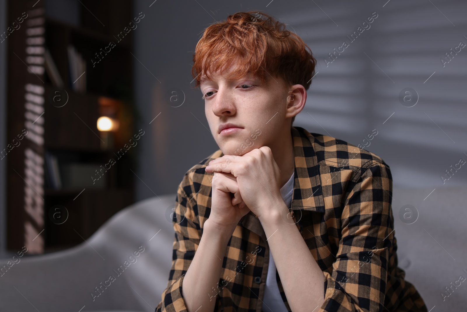 Teen problems. Depressed teenage boy at home Photo of Teen problems. Depressed teenage boy at home