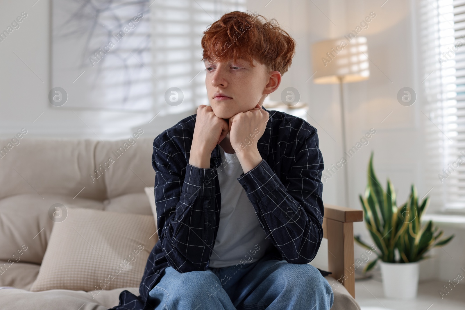 Teen problems. Depressed teenage boy on sofa at home Photo of Teen problems. Depressed teenage boy on sofa at home