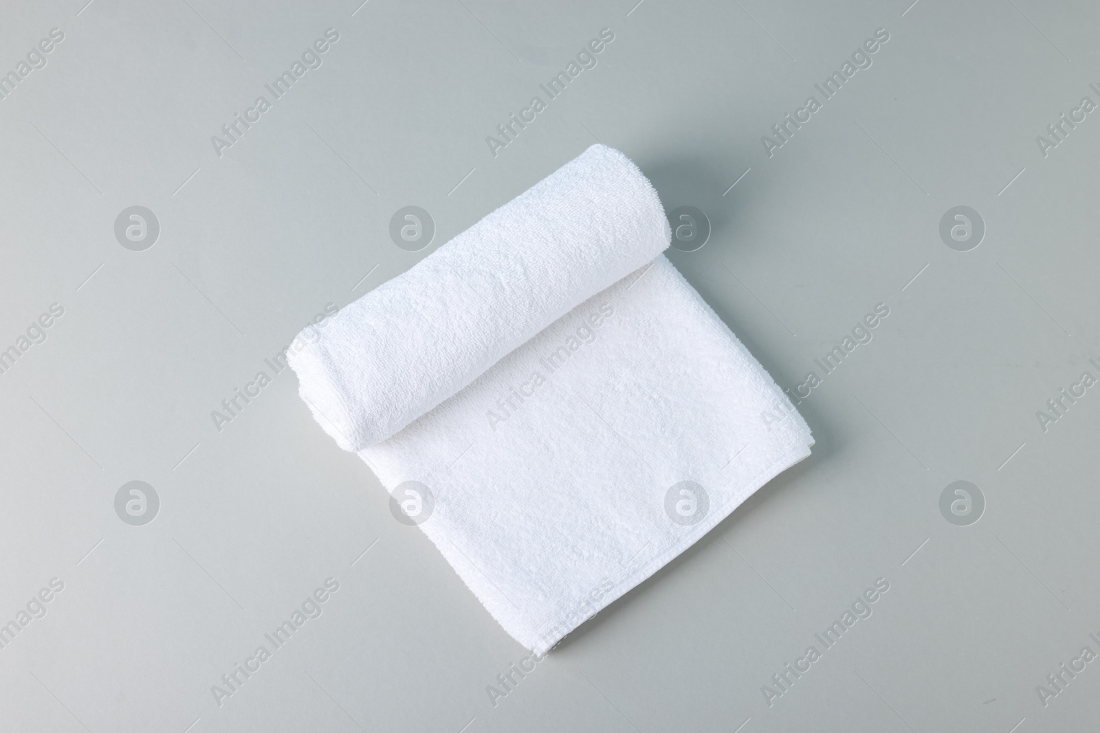 Clean towel on gray background, top view Photo of Clean towel on gray background, top view