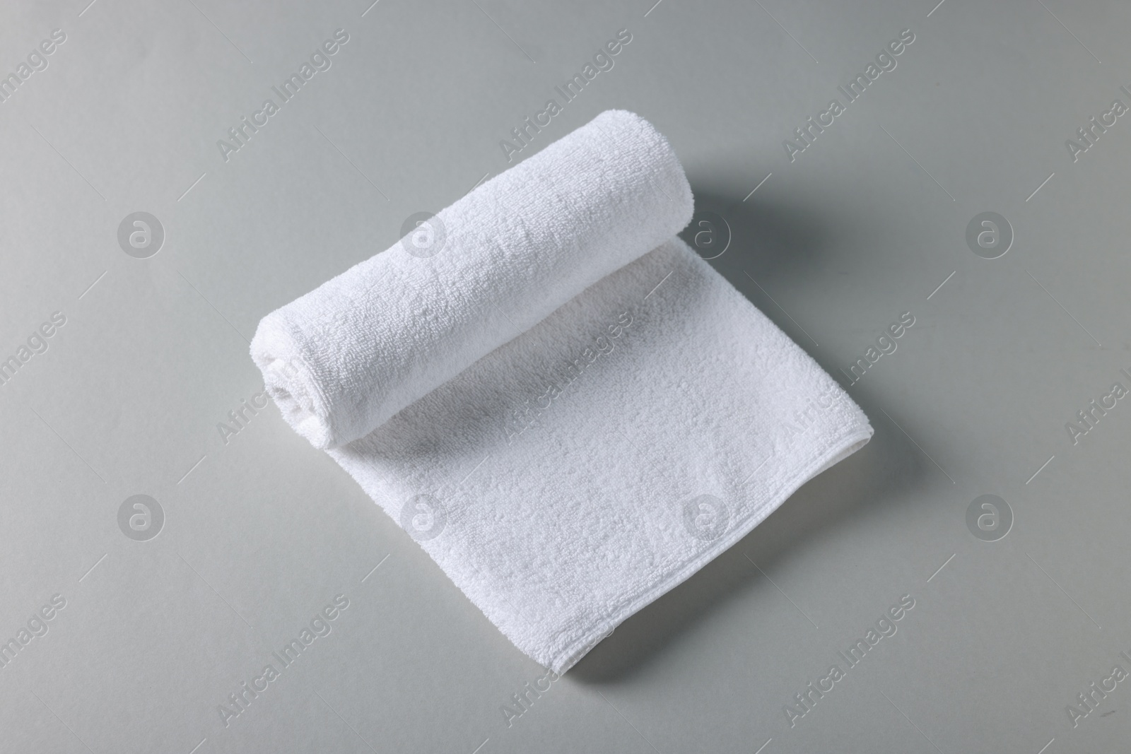 Clean towel on gray background, above view Photo of Clean towel on gray background, above view