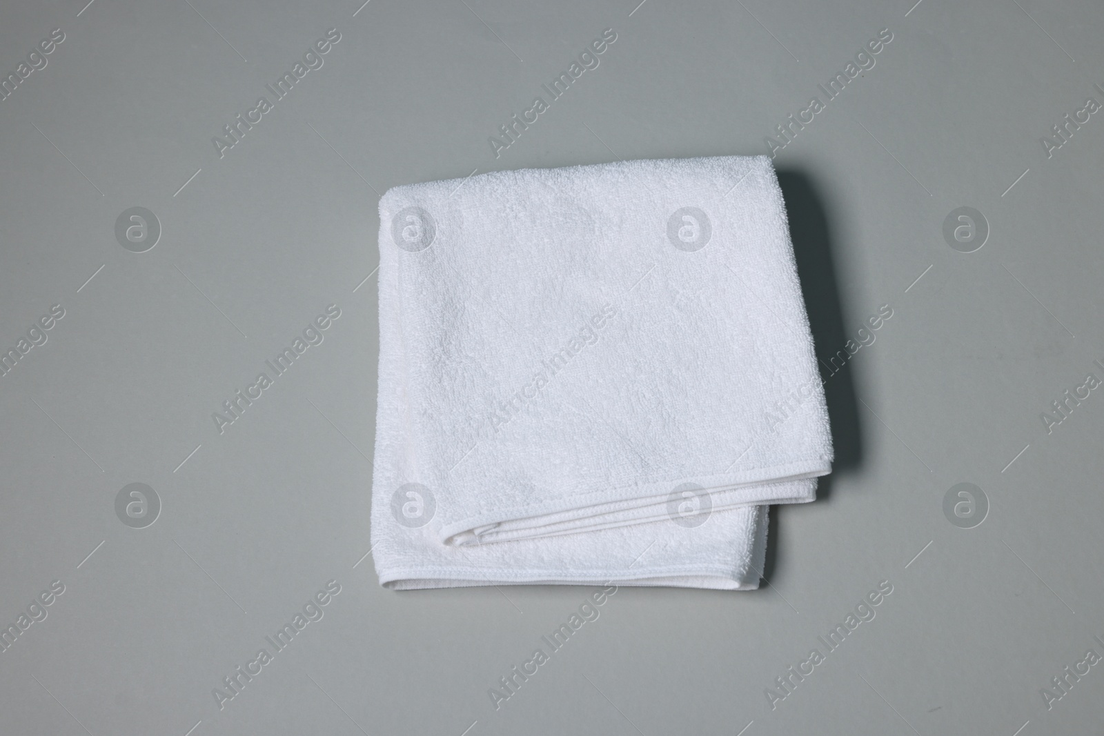 Clean towel on gray background, top view Photo of Clean towel on gray background, top view