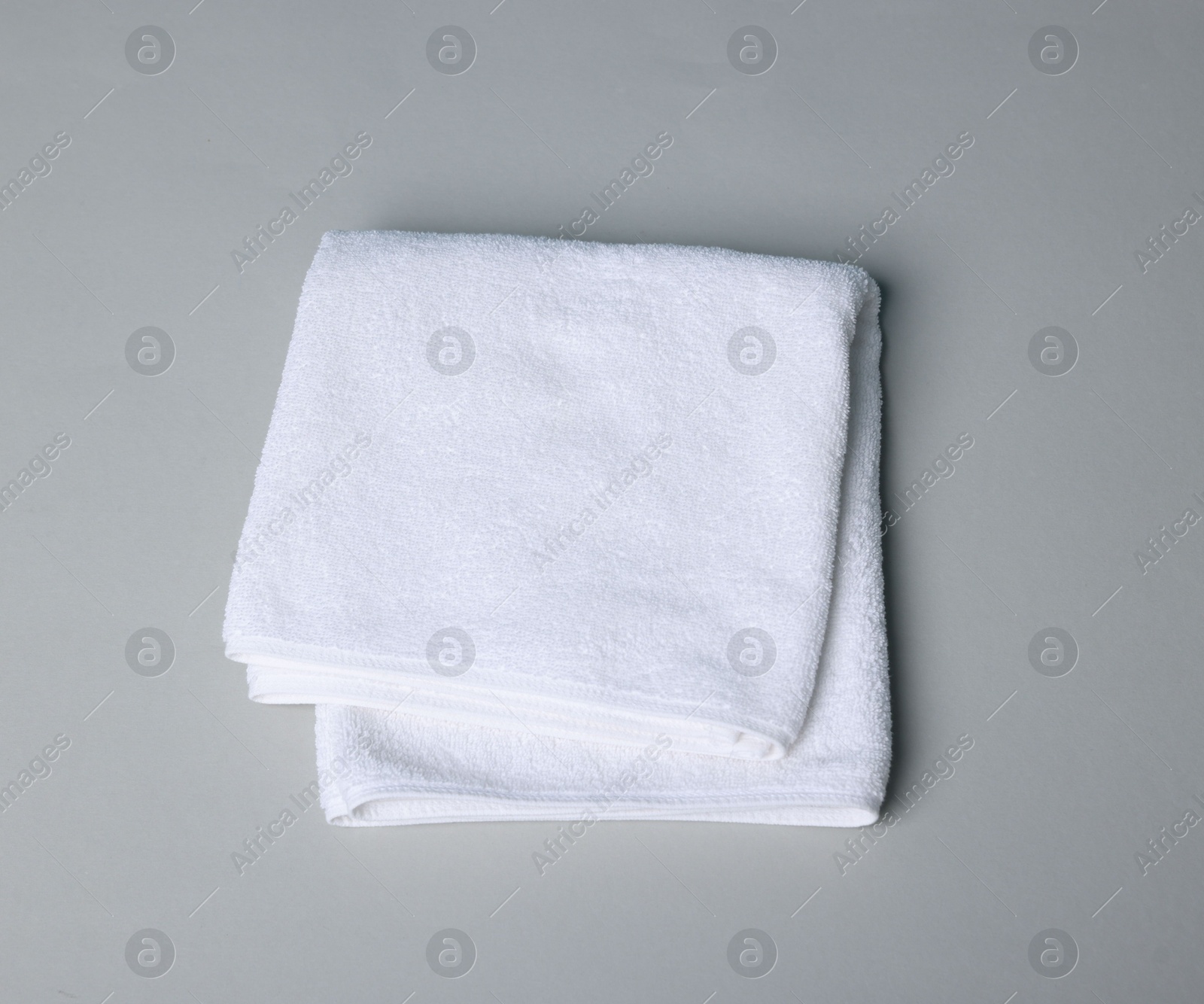Clean towel on gray background, top view Photo of Clean towel on gray background, top view
