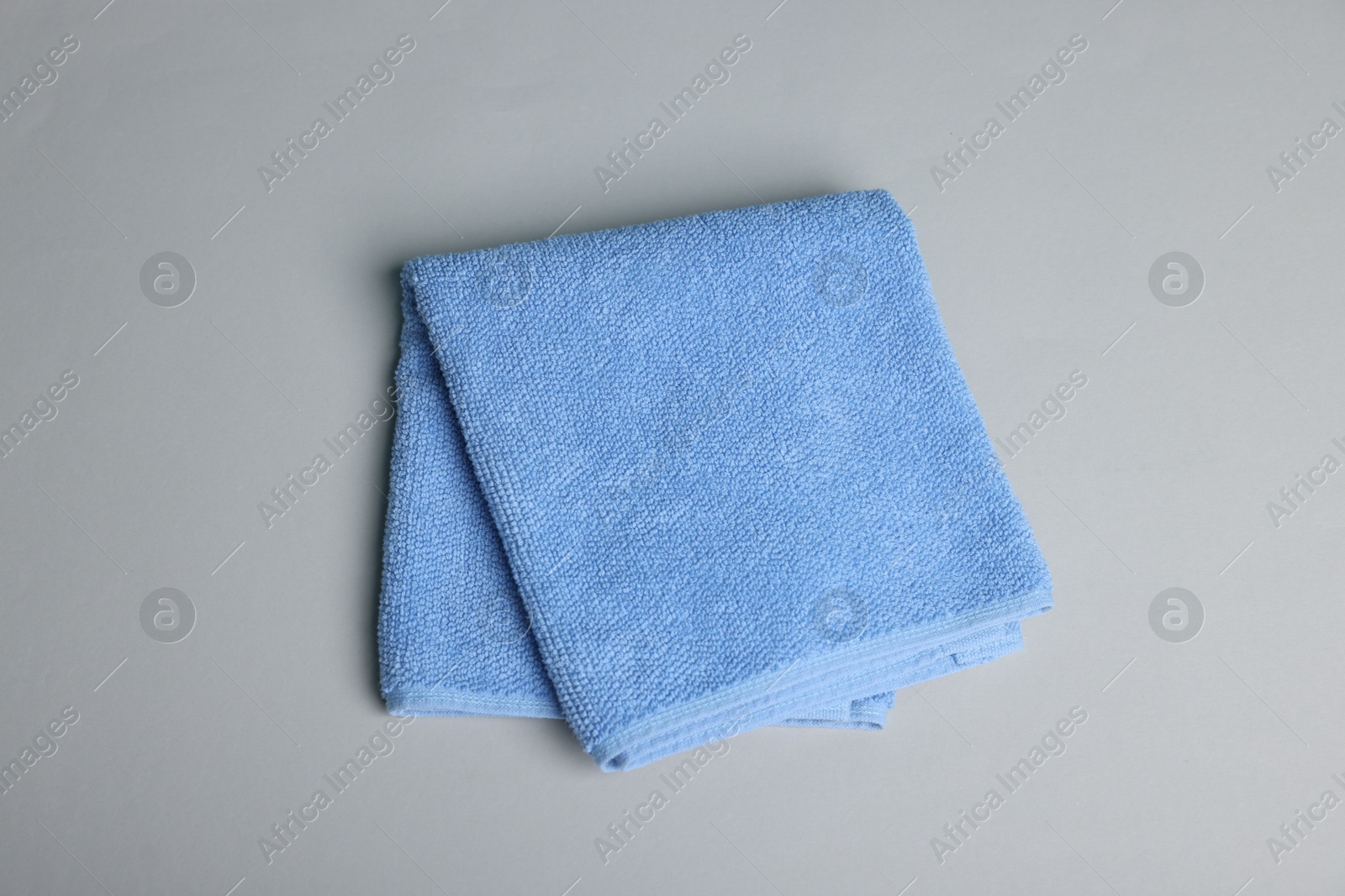 Clean towel on gray background, top view Photo of Clean towel on gray background, top view