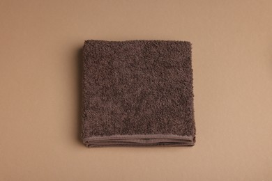 Photo of Clean towel on brown background, above view