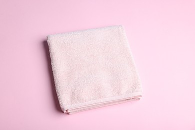 Photo of Clean towel on pink background, above view