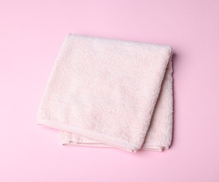 Photo of Clean towel on pink background, above view