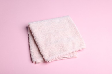 Photo of Clean towel on pink background, above view