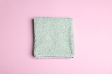 Photo of Clean towel on pink background, top view