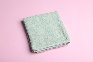 Photo of Clean towel on pink background, above view