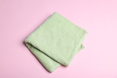 Photo of Clean towel on pink background, above view