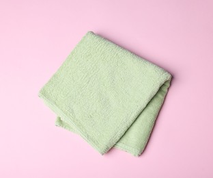 Photo of Clean towel on pink background, top view