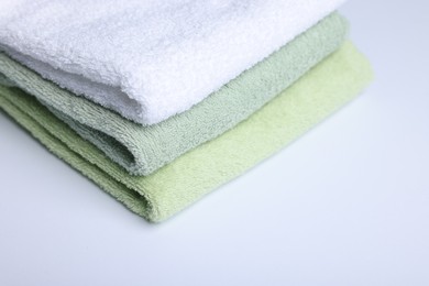 Photo of Stack of clean towels on white background, closeup
