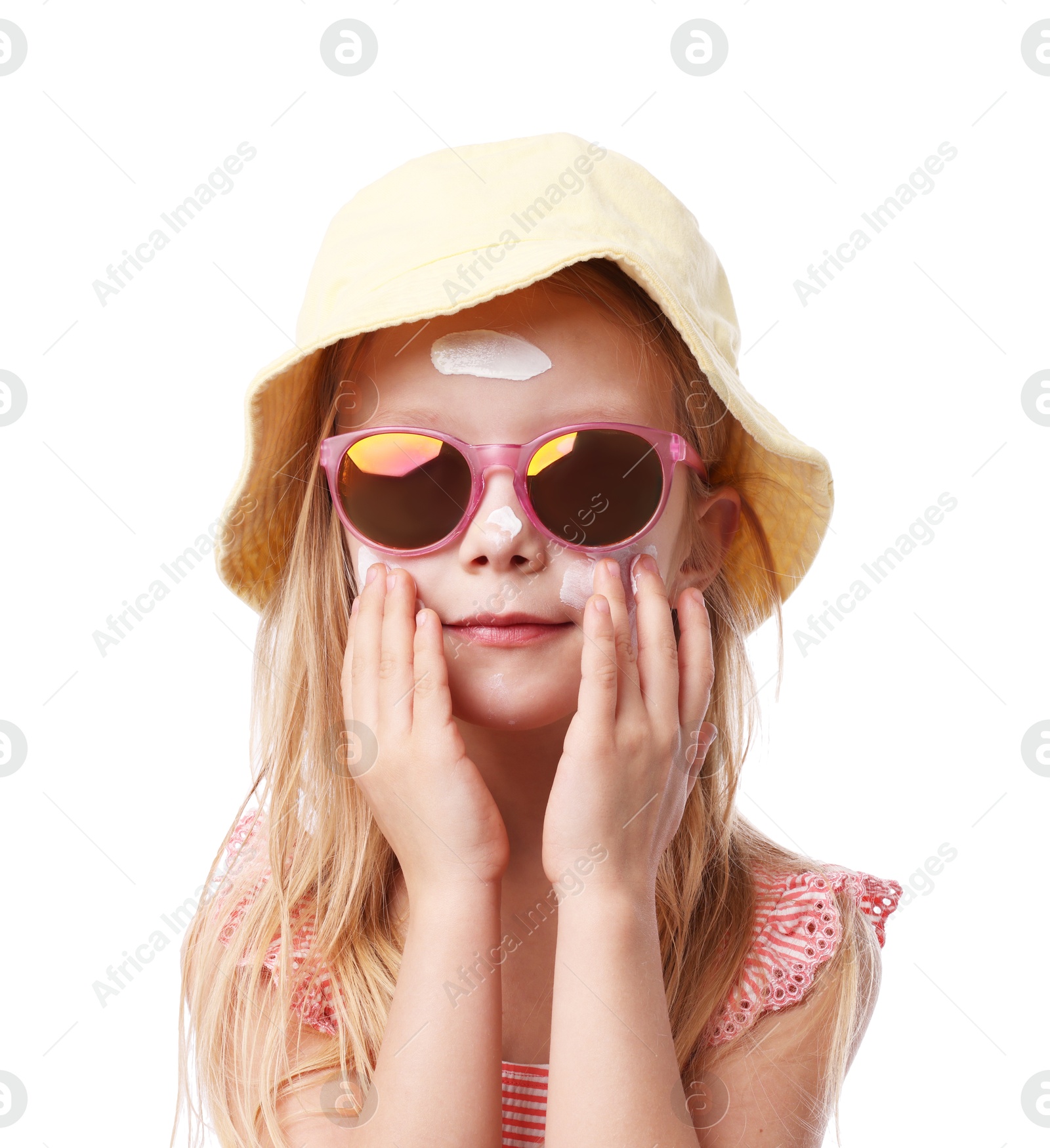 Photo of Cute little girl applying sun protection cream onto her skin against white background