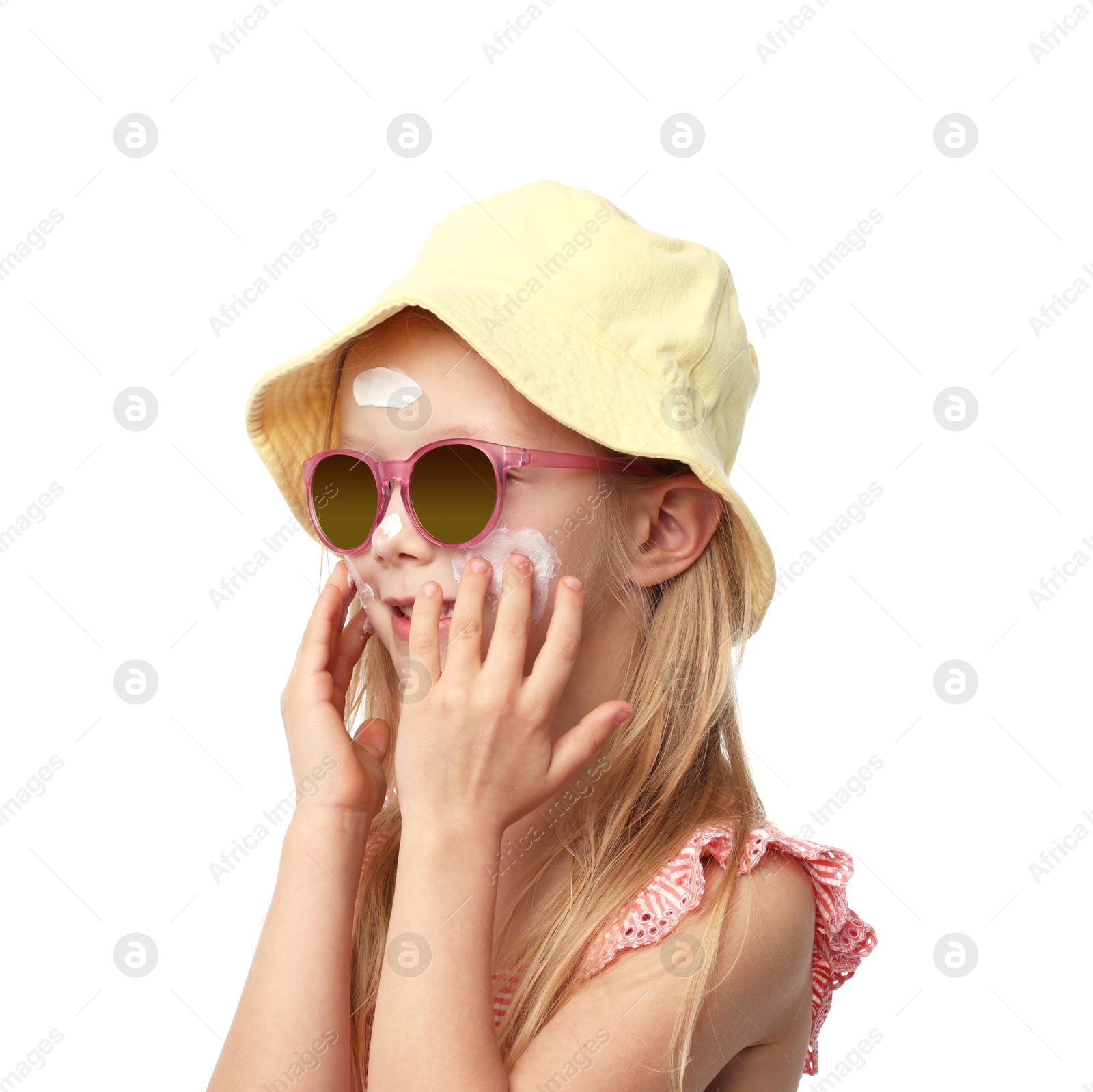 Cute little girl applying sun protection cream onto her skin against white background Photo of Cute little girl applying sun protection cream onto her skin against white background