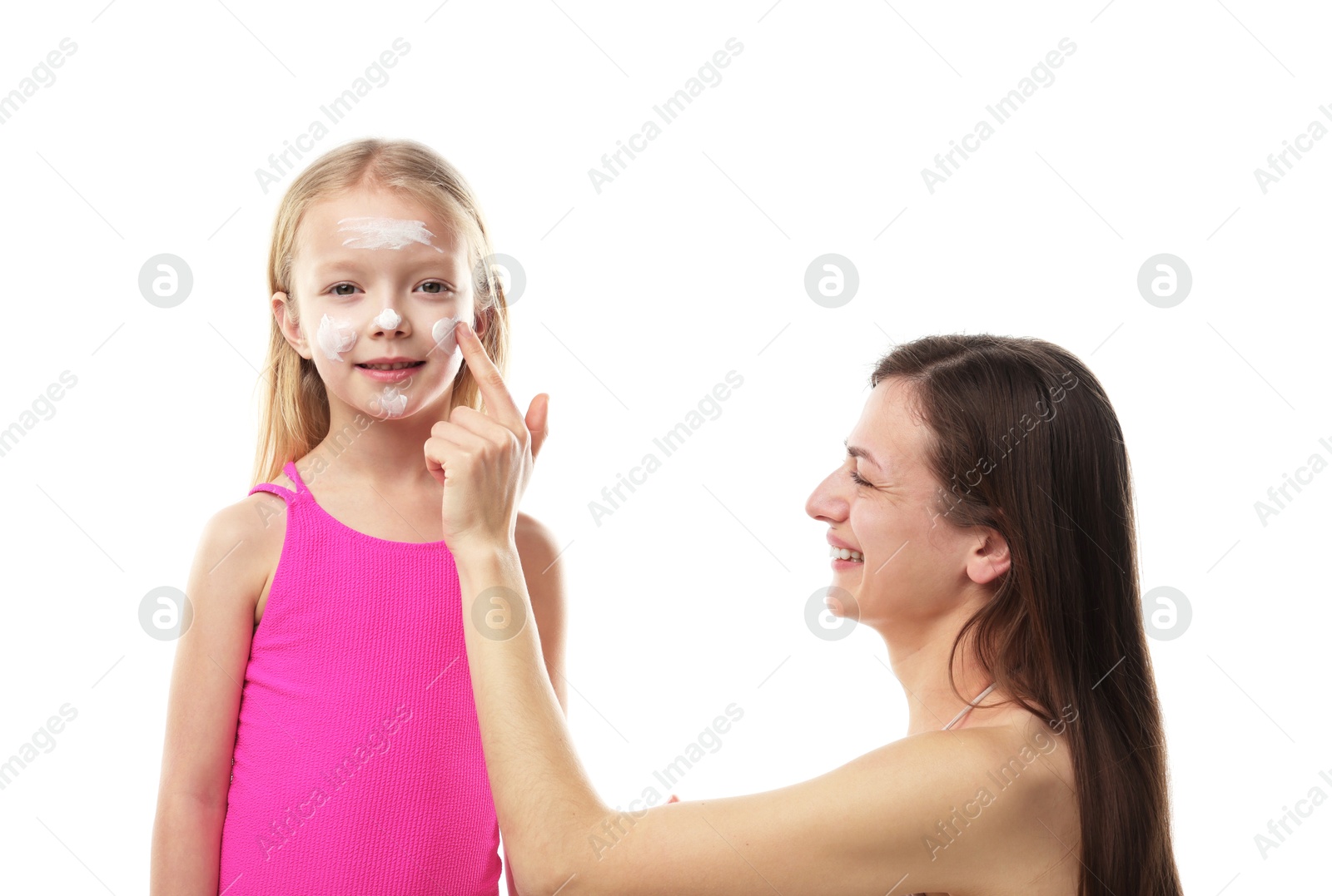 Smiling mother applying sun protection product onto her daughter's cheeks on white background Photo of Smiling mother applying sun protection product onto her daughter's cheeks on white background