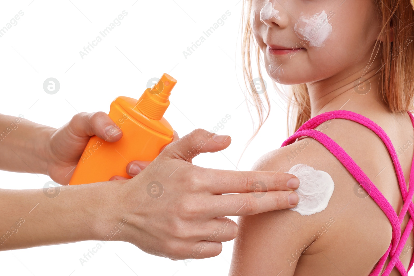Mother applying sun protection product onto her daughter's skin on white background, closeup Photo of Mother applying sun protection product onto her daughter's skin on white background, closeup