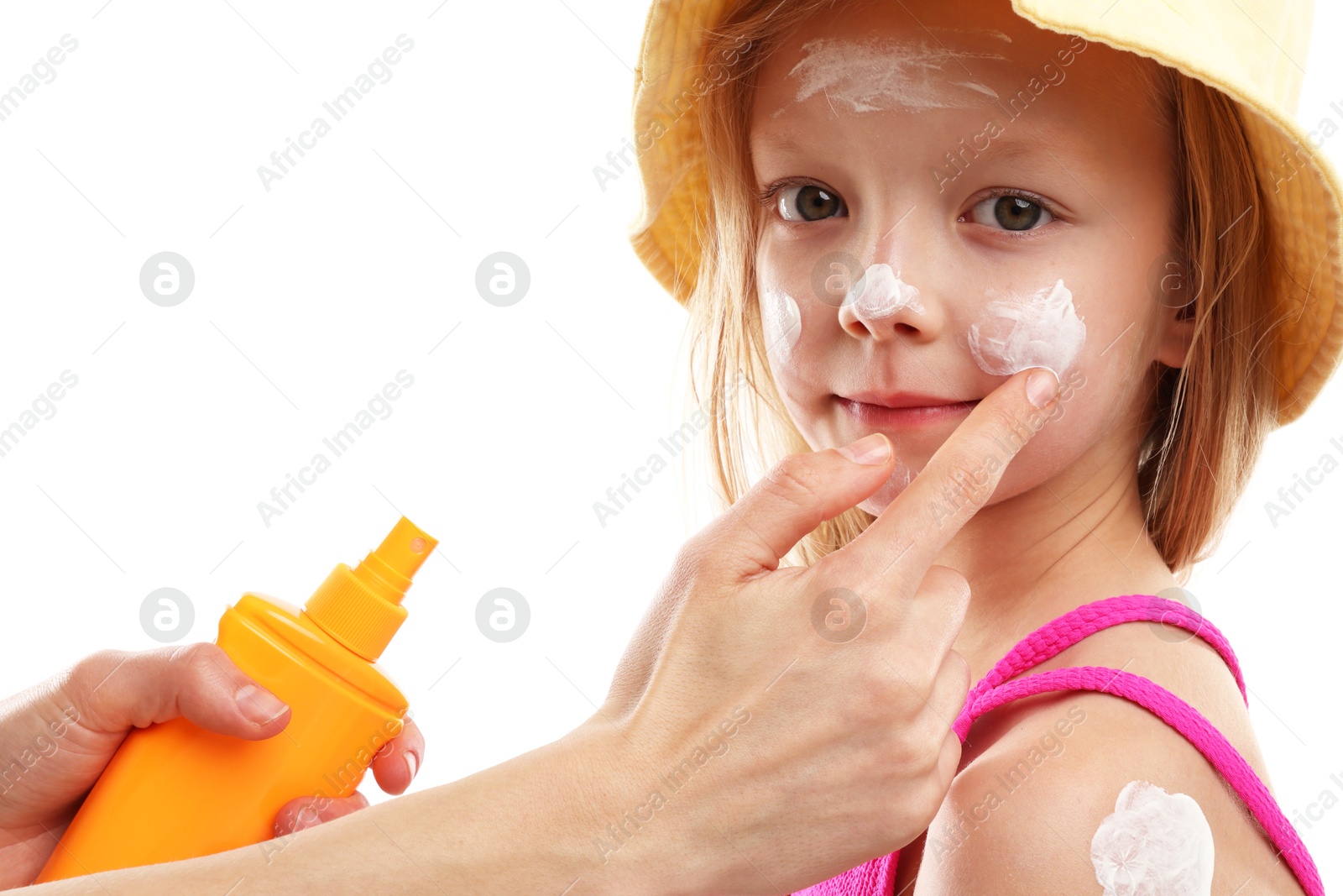 Photo of Mother applying sun protection product onto her daughter's skin on white background, closeup