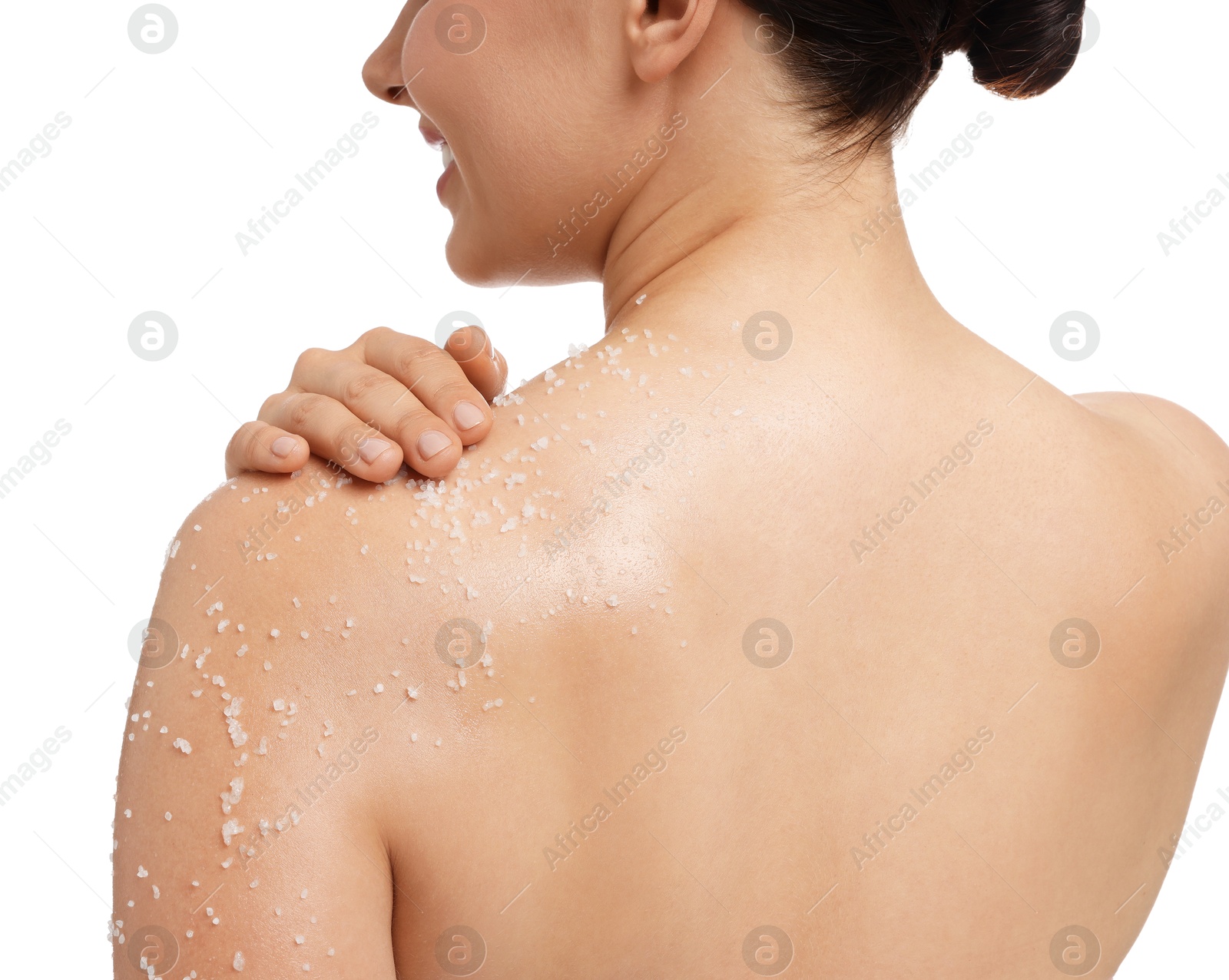 Photo of Woman applying body scrub onto her shoulder against white background, back view