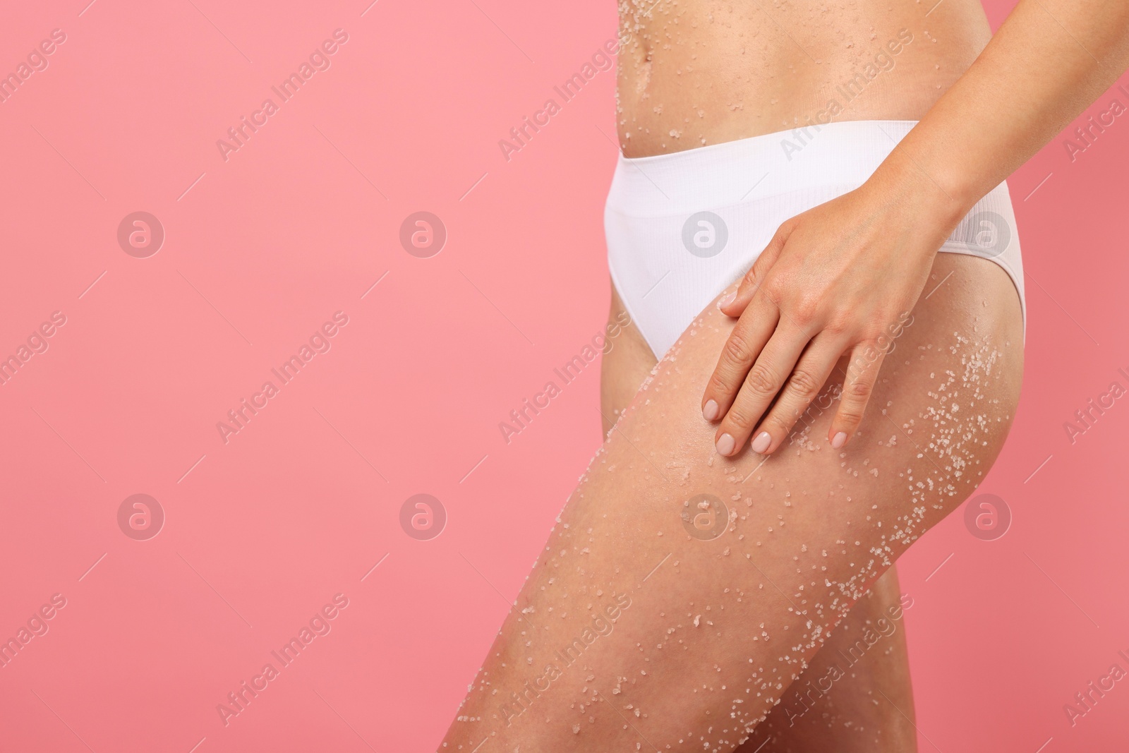 Woman with body scrub on her skin against pink background, closeup. Space for text Photo of Woman with body scrub on her skin against pink background, closeup. Space for text