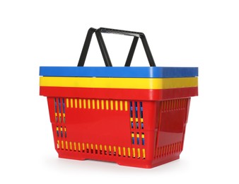 Photo of Stack of colorful shopping baskets isolated on white