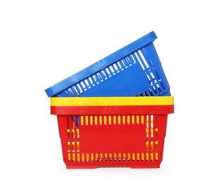 Photo of Stack of colorful shopping baskets isolated on white