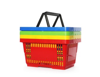 Photo of Stack of colorful shopping baskets isolated on white