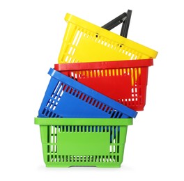 Photo of Stack of colorful shopping baskets isolated on white