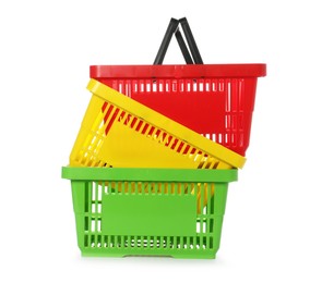 Photo of Stack of colorful shopping baskets isolated on white