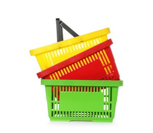 Photo of Stack of colorful shopping baskets isolated on white