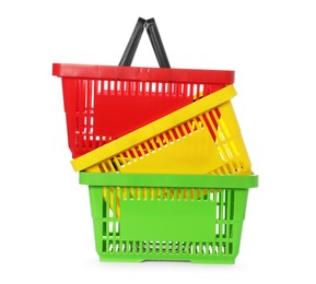 Photo of Stack of colorful shopping baskets isolated on white