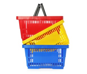 Photo of Stack of colorful shopping baskets isolated on white