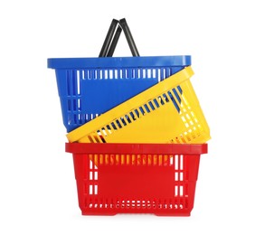Photo of Stack of colorful shopping baskets isolated on white