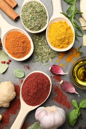 Photo of Different spices on grey table, flat lay
