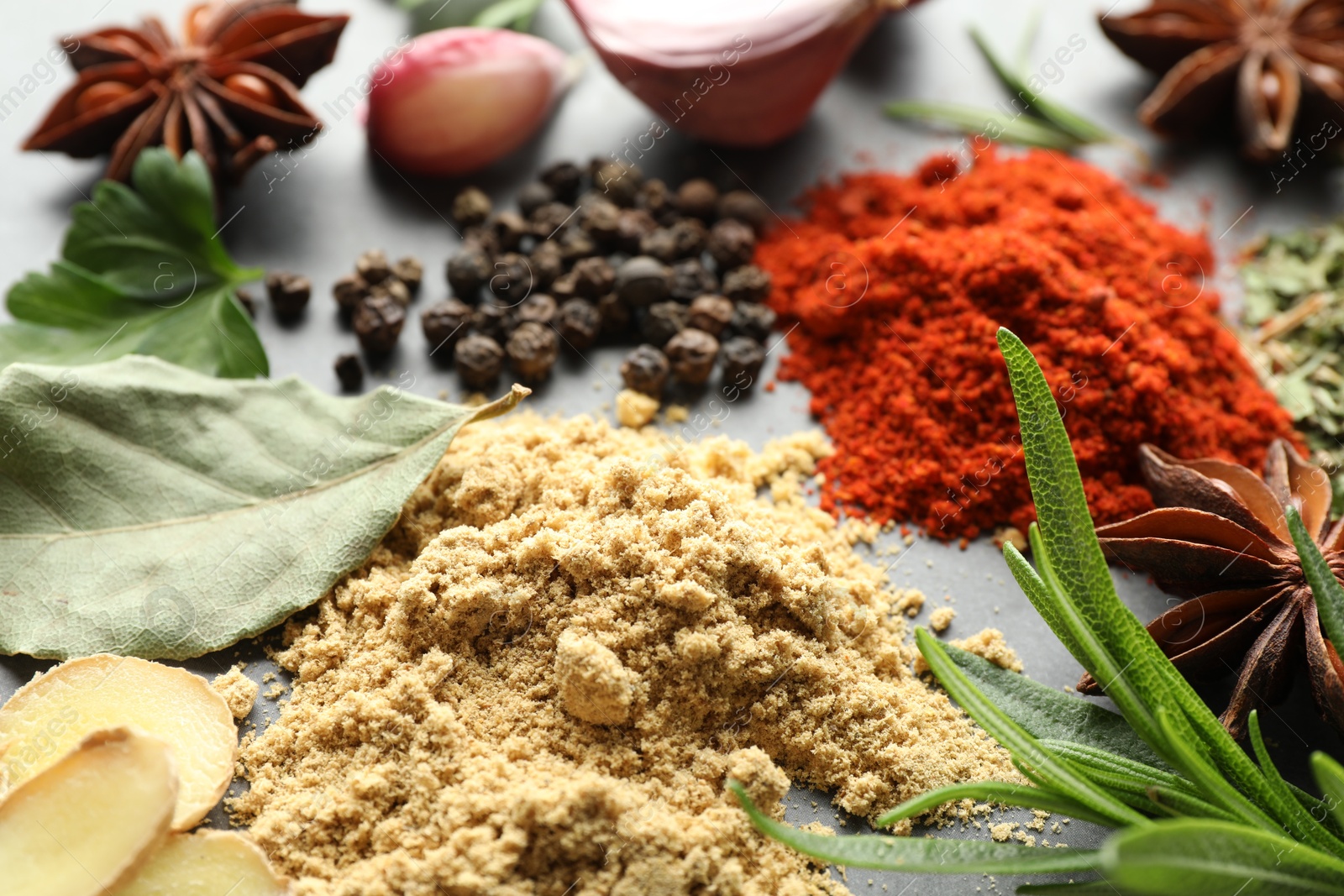 Many different spices on grey table, closeup Photo of Many different spices on grey table, closeup