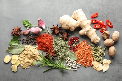 Photo of Different spices on grey table, flat lay