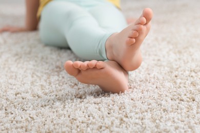 Photo of Girl on soft carpet at home, closeup