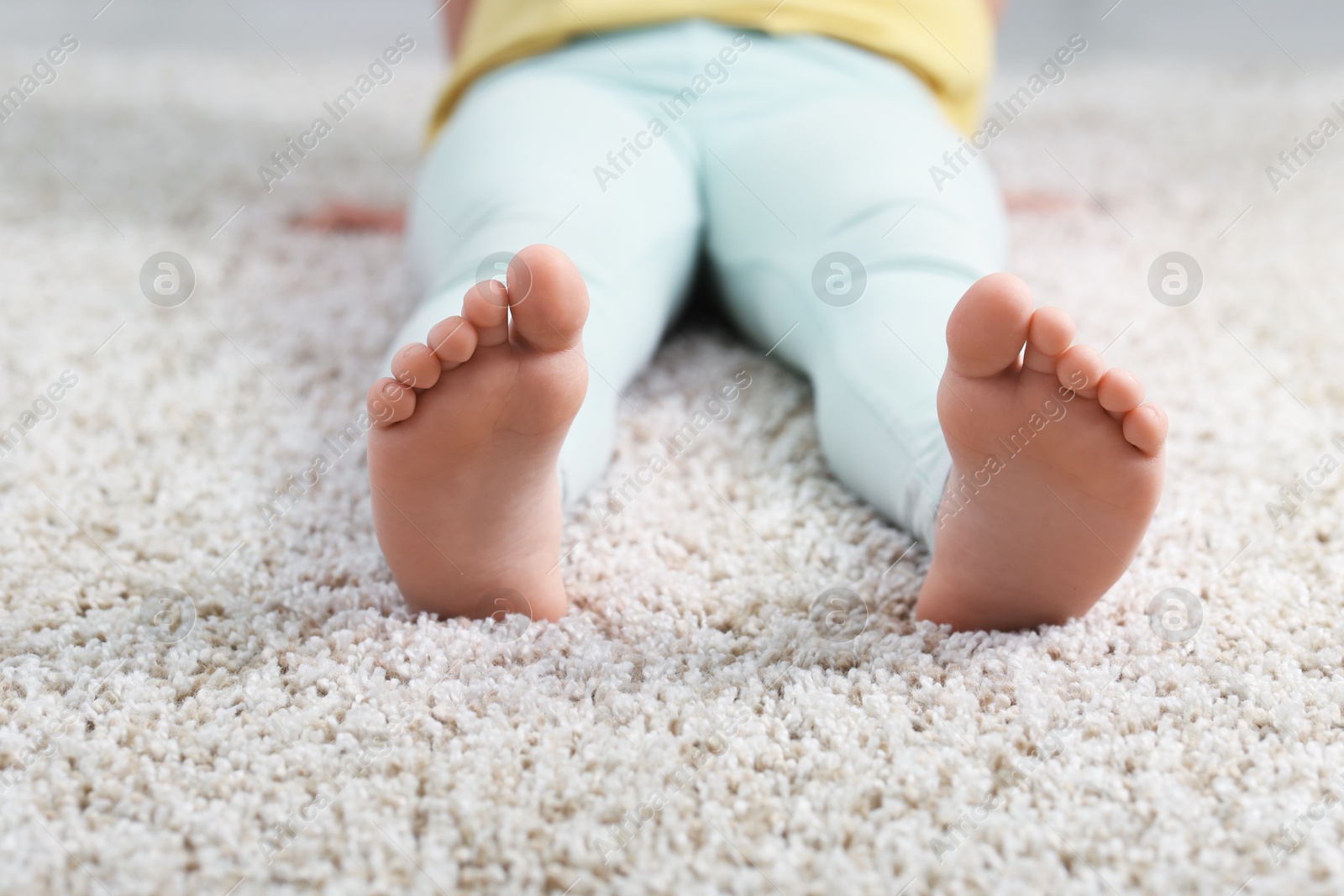 Girl on soft carpet at home, closeup Photo of Girl on soft carpet at home, closeup