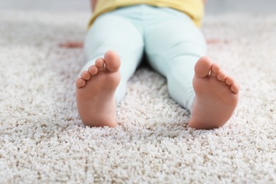 Photo of Girl on soft carpet at home, closeup