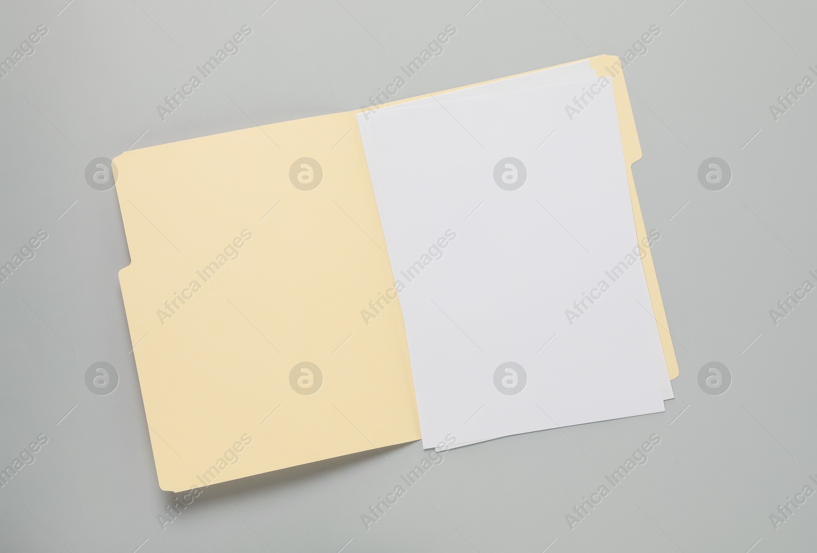 Paper file folder with blank sheets on gray background, top view Photo of Paper file folder with blank sheets on gray background, top view