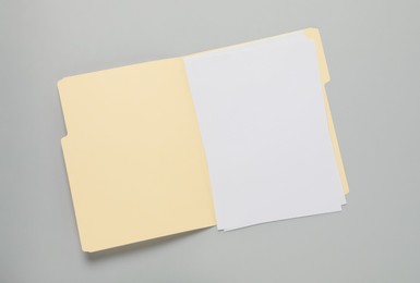 Photo of Paper file folder with blank sheets on gray background, top view